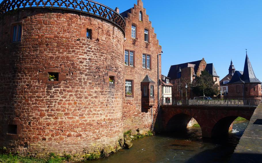 An old guard tower and house, with a bridge over the Seemenbach in Buedingen, Germany, is a popular photo motif for visitors to the old town. 