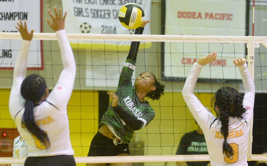 Kubasaki's Risha McGriff spikes against the double block of Kadena's Kyleigh Wright and Joan Buysman during Thursday's Okinawa volleyball match. The Dragons won in straight sets to improve to 4-0 in the season series.