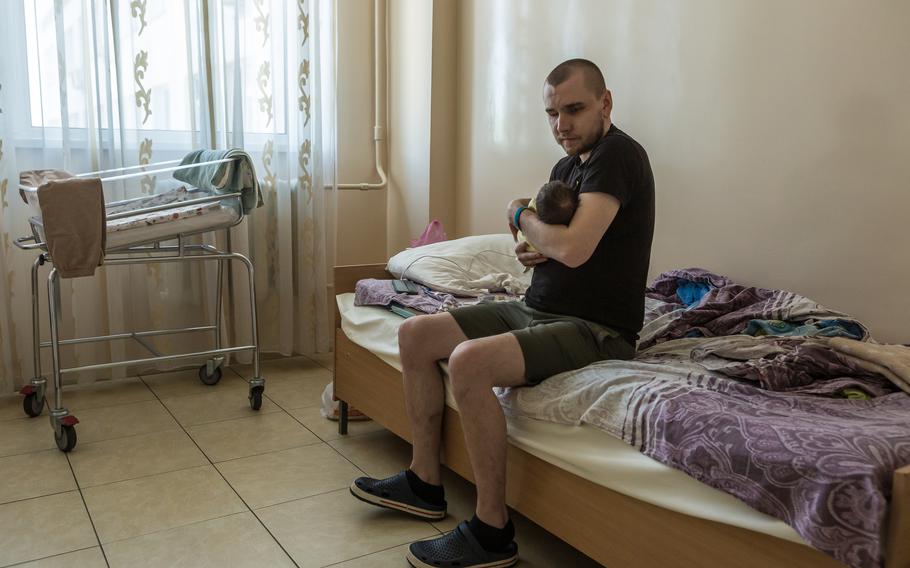 Ivan Soroka holds his newborn son at the maternity hospital.