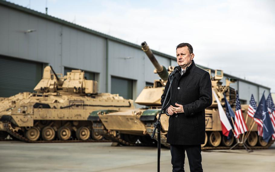 Mariusz Blaszczak, the Polish defense minister, speaks in Powidz on April 5, 2023, at the opening of a U.S. Army weapons depot. The facility in Poland will enable U.S. forces to dispatch an entire armored brigade faster, cutting deployment timelines with the pre-positioned weaponry.