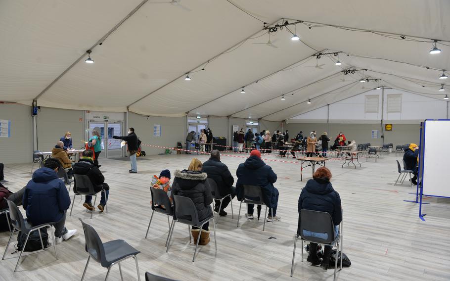 Patients sit during the mandatory waiting period after receiving a COVID-19 vaccine at Kaiserslautern Technical University, Germany, Nov. 30, 2021. The vaccine event was part of the Rheinland-Pfalz vaccine bus tours conducted by the German Red Cross.