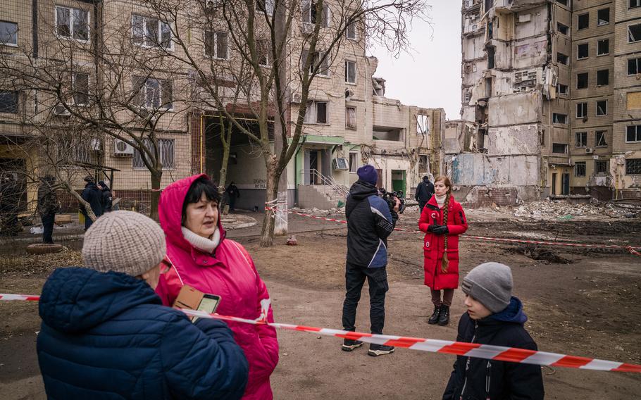 Humanitarian aid distribution takes place at the site of a Russian strike that destroyed part of a residential building in Dnipro, Ukraine, on January 17, 2023.