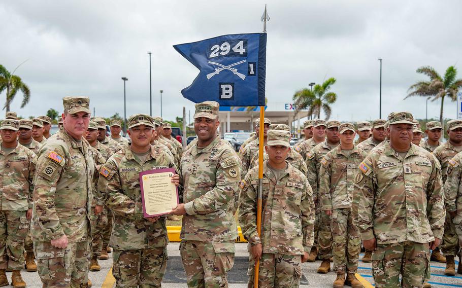 The head of U.S. Army Pacific, Gen. Ronald Clark, presents the Alexander Hamilton Award to Capt. Thomas Borgonia.