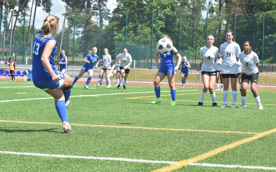 Ramstein's Abigail Belote lifts the ball over a Kaiserslautern wall and towards the goal Monday, May 20, 2024, in the opening round of the DODEA European Division I girls soccer championships at Ramstein High School. Audrey Singer, making her way to the ball in the background just left of the wall, would score on the play.