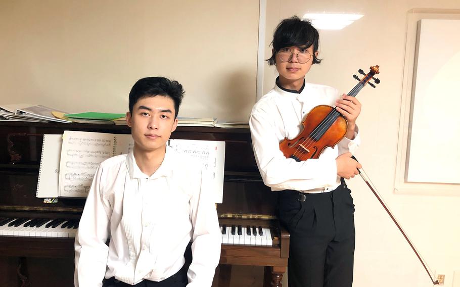 Brothers David Lee, right, a high school senior at Osan Air Base, South Korea, and Ralph Lee, an Osan graduate, founded Music Echoes to produce free music for hospital and nursing home patients during the pandemic.   