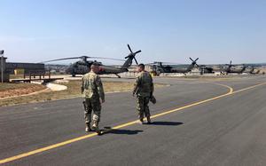 Two members of the Vermont Army National Guard walk down the flight line at Camp Bondsteel in Kosovo. The Vermont battalion deployed to in July for a rotation lasting at least nine months.