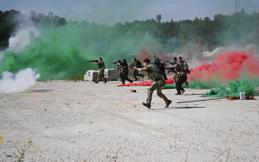 Special Forces candidates assigned to the U.S. Army John F. Kennedy Special Warfare Center and School assault enemy role players as they take part in the final phase of field training known as Robin Sage in central North Carolina, Sept. 28, 2021.