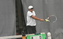Micah San Pedro of Kaiserslautern uses a two-handed backhand in the boys doubles final at the DODEA-Europe tennis championships Saturday, Oct. 23, 2021.