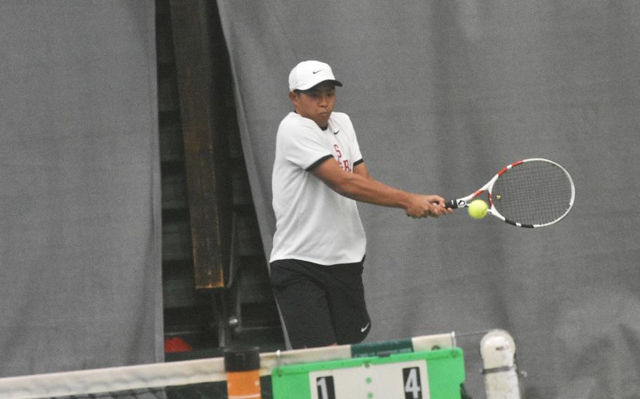 Micah San Pedro of Kaiserslautern uses a two-handed backhand in the boys doubles final at the DODEA-Europe tennis championships Saturday, Oct. 23, 2021.