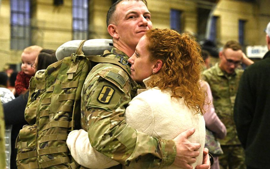 Sgt. 1st Class John Nedeau and fiancée Katie Crisman embrace during a a welcome home ceremony for the 3rd Battalion, 197th Field Artillery Regiment on Feb. 8, 2024, at the Manchester, N.H., armory.