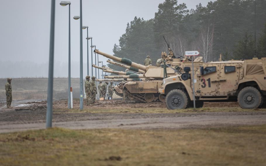 U.S. soldiers line up their M1A2 Abrams tanks on the firing range in Bemowo Piskie, Poland, on Feb. 16, 2023. Since Russias invasion of Ukraine last year, the number of American troops in Poland has increased to about 10,000. Those forces operate in the country on a rotational basis.