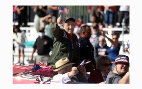 Onofrio "No-No" Zicari, a World War II veteran, waves at the crowd during the Veterans Day parade on Fourth Street in downtown Las Vegas on Nov. 11, 2021. (Erik Verduzco / Las Vegas Review-Journal) @Erik_Verduzco