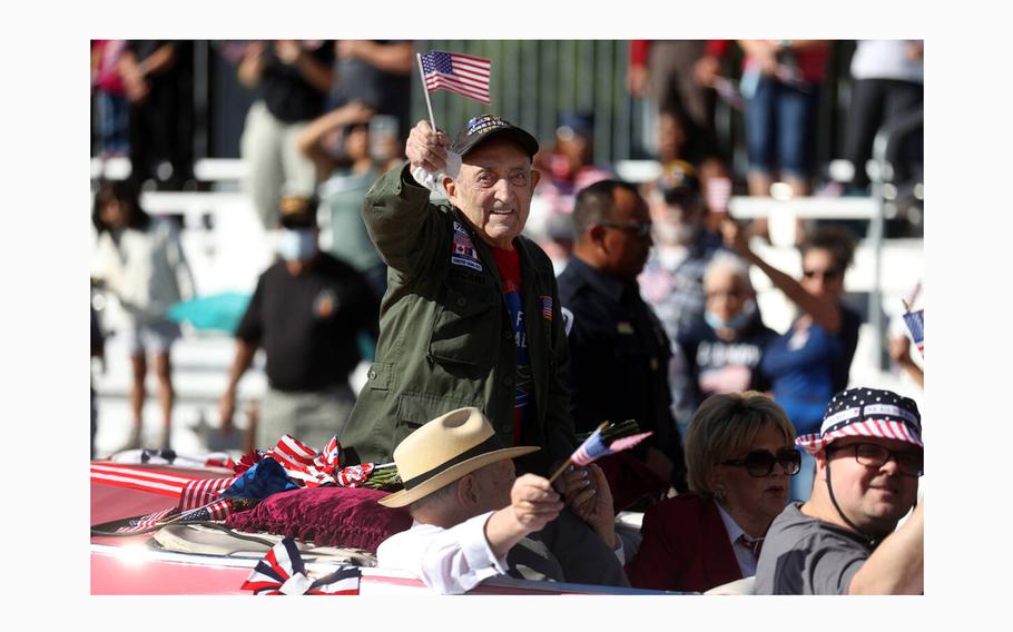 Onofrio “No-No” Zicari, a World War II veteran, waves at the crowd during the Veterans Day parade on Fourth Street in downtown Las Vegas on Nov. 11, 2021. 