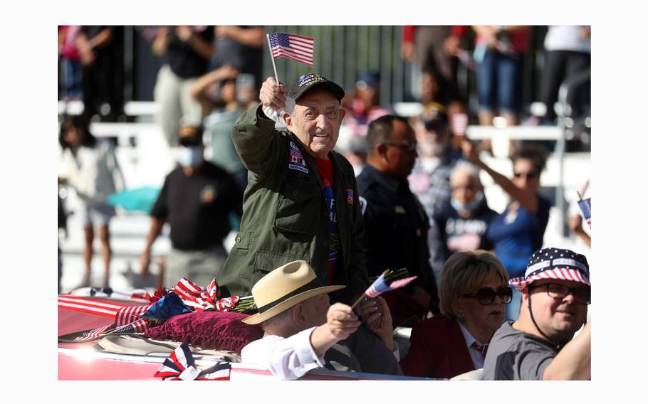 Onofrio “No-No” Zicari, a World War II veteran, waves at the crowd during the Veterans Day parade on Fourth Street in downtown Las Vegas on Nov. 11, 2021. 