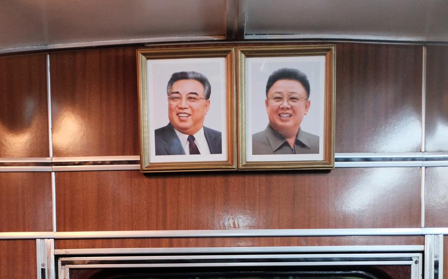 Framed photos of deceased North Korean leaders Kim Il Sung, left, and Kim Jong Il hang inside a train car in Pyongyang, North Korea, in 2016. 