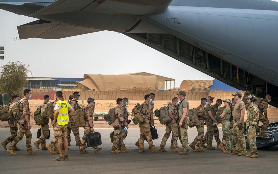 French Barkhane force soldiers board a US Air Force C130 transport plane as they leave their base in Gao, Mali Wednesday June 9, 2021. France has suspended joint military operations with Malian forces until the junta led by Col. Assimi Goita, who retook control of Mali's transitional government May 24, complies with international demands to restore civilian rule.