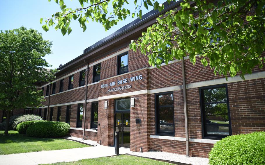 A brick building with silver letters reading “88th Air Base Wing headquarters.”