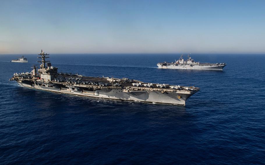 The aircraft carrier USS Dwight D. Eisenhower sails beside the amphibious assault ship USS Wasp in the Mediterranean Sea, June 30, 2024. Six service members from Wasp were flown on an MH-60 Seahawk helicopter to Eisenhower for reunions with family members on June 30, 2024.