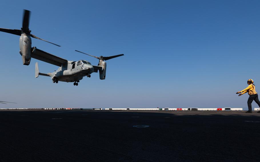 A U.S. sailor assigned to the amphibious assault ship USS Bataan signals to an MV-22B Osprey to land on the ship’s flight deck in the Persian Gulf on Oct. 11, 2023.