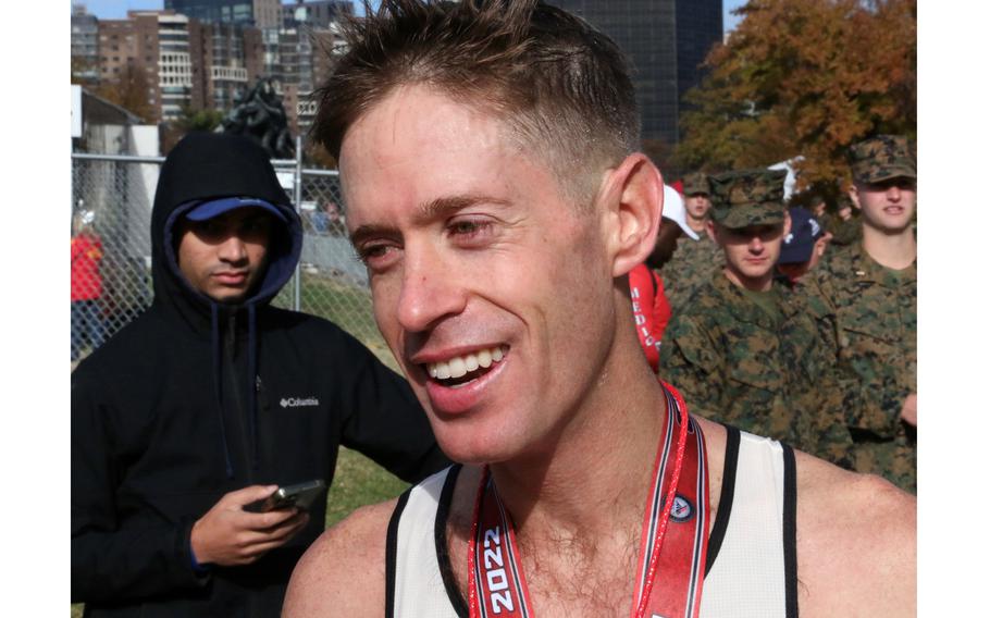 Marine Capt. Kyle King relaxes after winning the Marine Corps Marathon on Sunday, Oct. 30, 2022, in Arlington, Va.