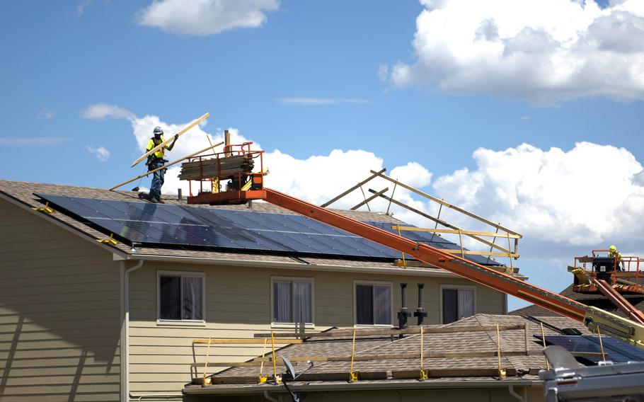 Construction workers replace the shingles on roofs at Tierra Vista Communities at Schriever Air Force Base, Colo., July 8, 2019. 