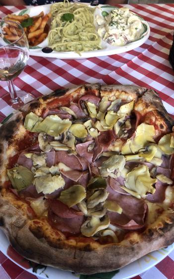 Menu items No. 19 and No. 63, a pizza and a pasta dish, respectively, at Pizza and Pasta Da Angelo, a beloved and historic Frankfurt pizzeria.