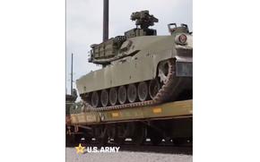 A tank on a rail car in a video.