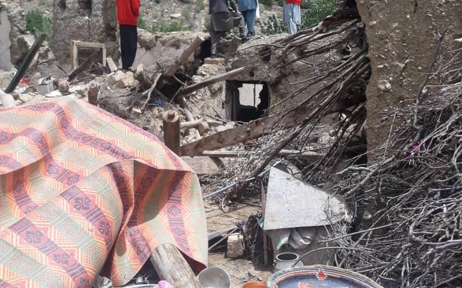 Residents of Paktika province in Afghanistan survey the damage June 24, 2022, in the aftermath of a 5.9-magnitude earthquake that struck the region two days earlier.