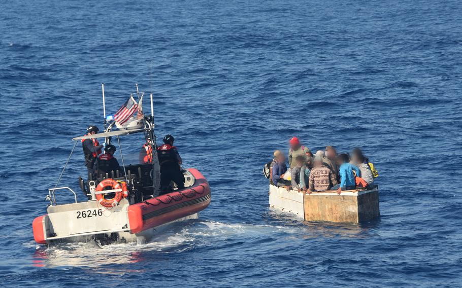 A crew from the Coast Guard Cutter Charles Sexton approaches 17 Cuban migrants aboard a rustic vessel approximately 54 miles south of Key West, Florida, March 18, 2021. 