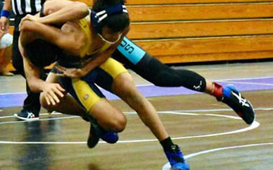 Guam High's Chris Angoco and Southern's Benjamin Topasna seek the upper hand at 124 pounds during Saturday's Guam wrestling dual meet. Topasna pinned Angoco and the Dolphins won the meet 39-27.