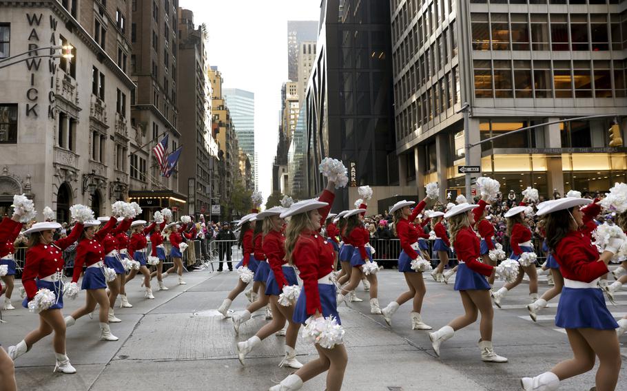 Cheerleaders make their way down Sixth Avenue during the Macy’s Thanksgiving Day Parade, Thursday, Nov. 24, 2022, in New York.
