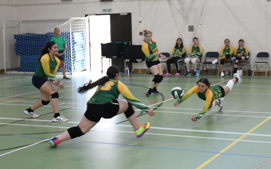 Alconbury Dragons' Lorna Lee puts her body on the line to try to dig a spike from the Spangdahlem Sentinels.
