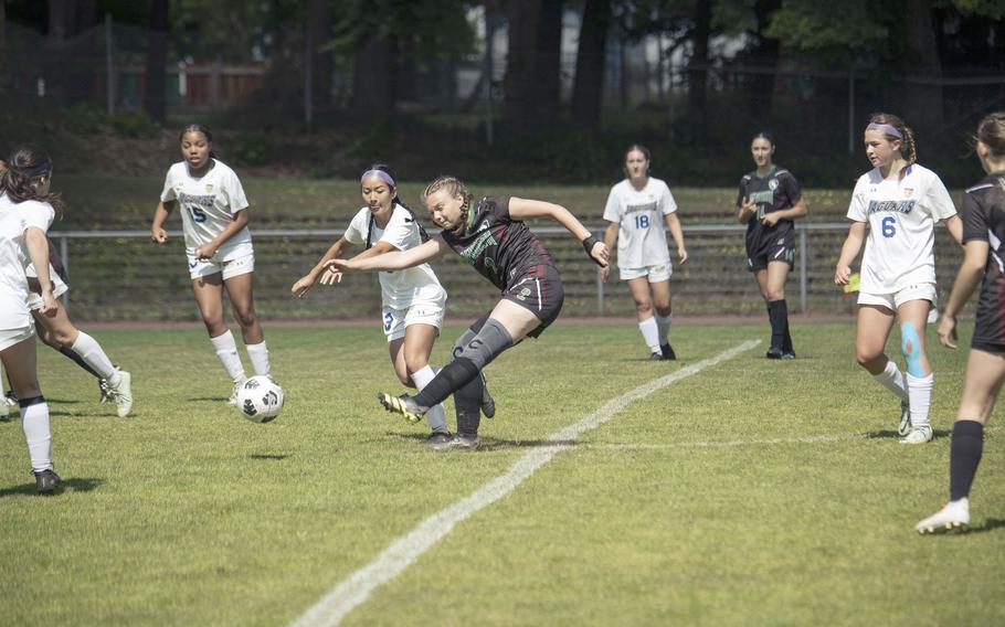 AFNORTH sophomore Emery Koger passes the ball to a teammate while contested by players from the Sigonella Jaguars during their first match of the 2025 DODEA European Division III soccer championships in Landstuhl, Germany on May 19, 2025.
