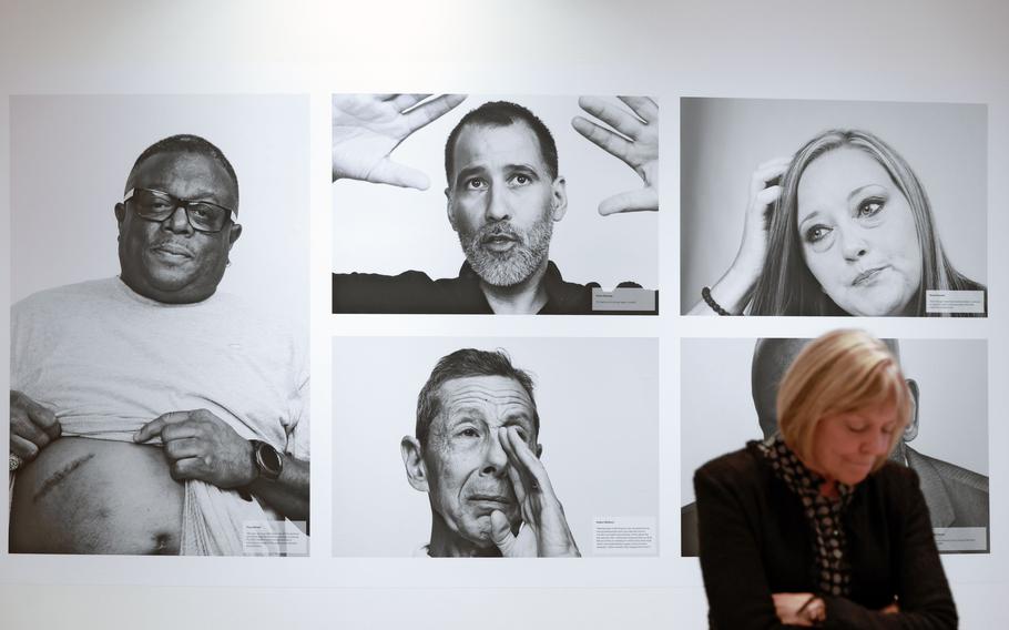 CDC Museum Director Judy Gantt stands in front of portraits of members of the WTC Health Program at “The Health Effects of 9/11” exhibit at The David J. Sencer CDC Museum on Thursday, Sept. 7, 2023.