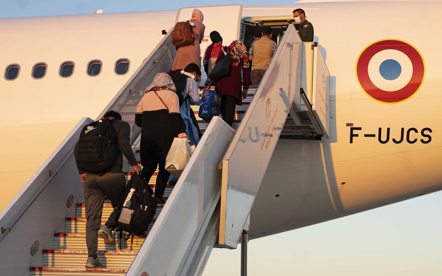 Evacuees from Afghanistan board a flight on Sept. 2, 2021, to the United States at Naval Station Rota in Spain. The Rota base is supporting the Department of State mission to facilitate the safe relocation of U.S. citizens, Afghans seeking special immigration visas, and other vulnerable Afghans.