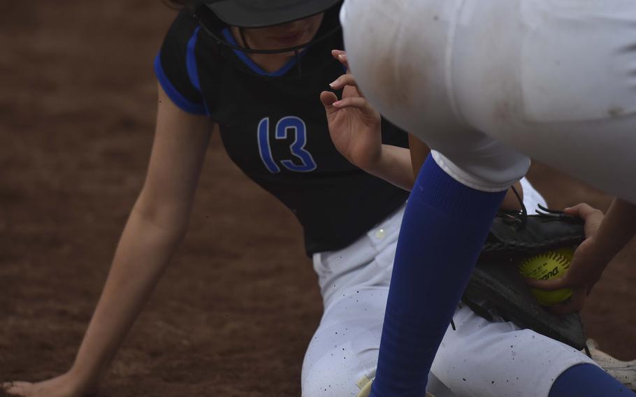 Hohenfels freshman Emily Burnside is tagged out by Rota senior Alana Geylani during day two of the DODEA-Europe softball championships on May 23, 2024, in Kaiserslautern, Germany.
