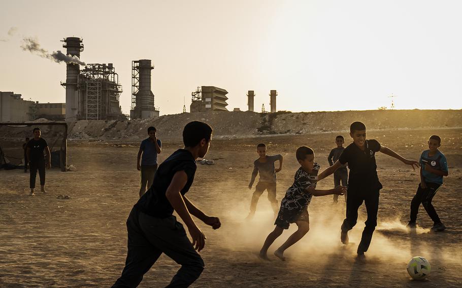 Children play soccer at sunset in the Bedouin village of Wadi al Naam.