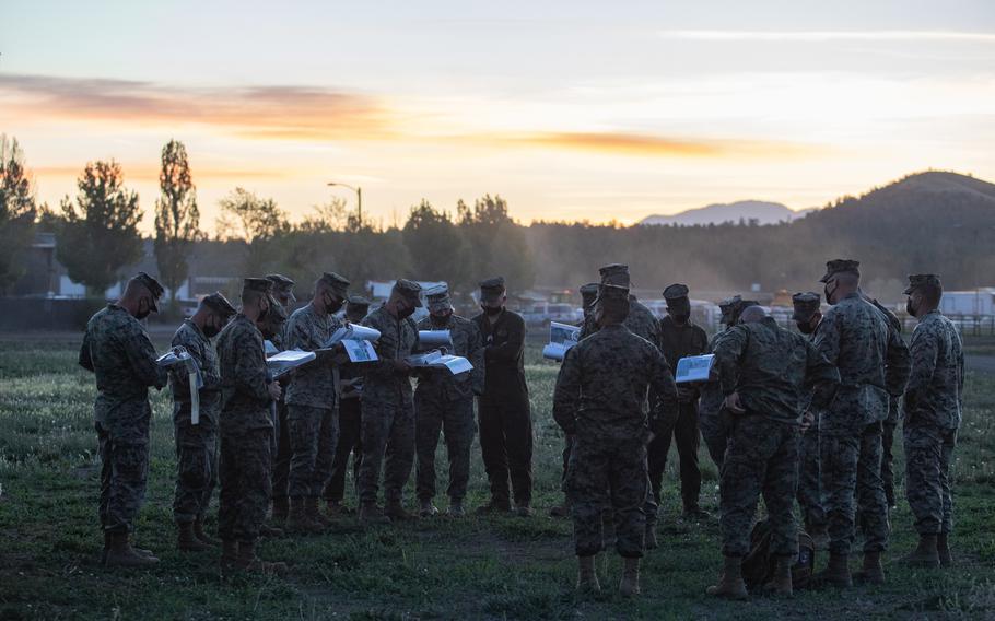 Marines conduct a briefing before departing Williams, Ariz., May 15, 2021. Marines in tactical vehicles and trucks drove from Camp Lejeune, N.C., to Twentynine Palms, Calif., in one of the longest convoys in the service's history.