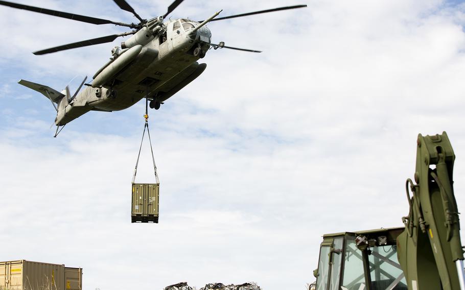 A CH-53E Super Stallion from Marine Heavy Helicopter Squadron 462 airlifts equipment for the Poseidon’s Watchtower exercise on Irisuna Island, Okinawa, June 3, 2021. 