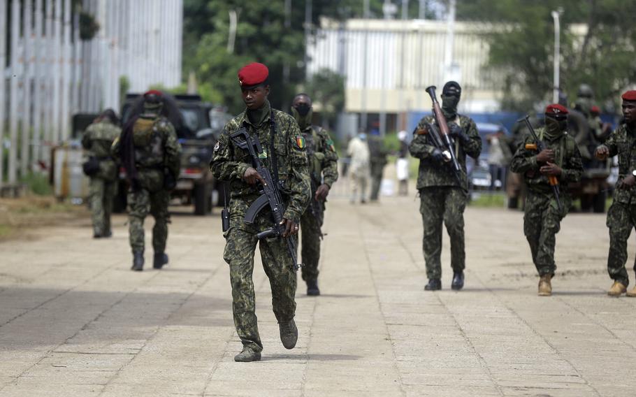 Guinean soldiers patrol outside the Presidential palace in Conakry, Guinea Friday, Sept. 10, 2021.