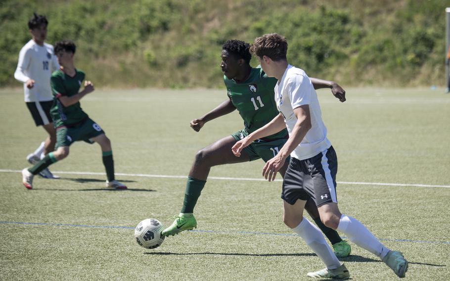 Marc Kpade, a senior with the AFNORTH Lions, is contested by a player from the Brussels Brigands in their second match of the 2025 DODEA European Division III soccer championships in Landstuhl, Germany on May 19, 2025. 