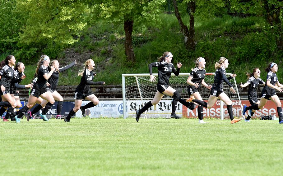 The Vicenza girls soccer team celebrates after winning their Division II semifinal match with Black Forest Academy at the DODEA European soccer championships on May 17, 2023, at VfR Baumholder's stadium in Baumholder, Germany. The Cougars defeated the Falcons 4-3 on penalty kicks.