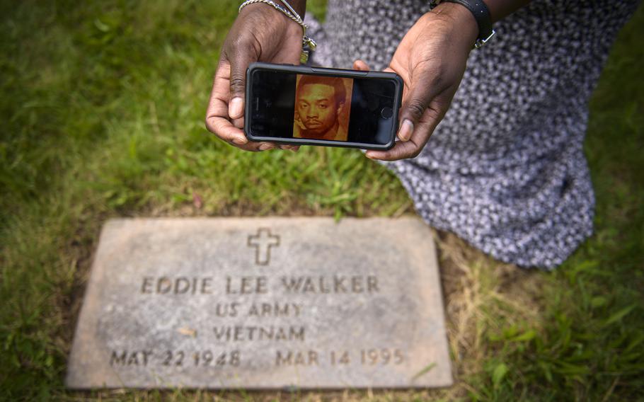 Windsor resident Sonia Turner displays a photograph of her father, Eddie Lee Walker, a Vietnam War veteran. Turner said grass was covering her father's headstone but was cleared when she complained to Hartford officials about the neglect of her father's gravesite. But while the stone of her father, a Vietnam veteran, had been raised and the grass cut away, other stones over other veterans' graves remain neglected. Turner says she won't stop pressing the issue until all the grave sites at the Hartford-maintained cemetery are treated with the dignity they deserve.