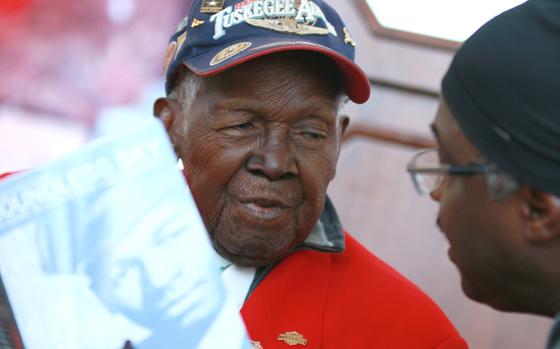Tuskegee Airman Lt. Calvin Spann talks to a  Black History Month celebration attendee at the National Airport in Washington, D.C. February 24, 2015.
   
Hear Lt. Spann recount flying his P-51 Mustang fighter plane against the Germans' jet aircraft on Stars and Stripes' YouTube channel here https://www.youtube.com/watch?v=xPcO6JeypOQ

META TAGS: Tuskegee airmen; Air Force; Black History Month; African American; 