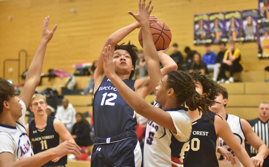 Black Forest Academy’s Nehemiah Perryman goes up for a basket while defended by Aviano’s Deon Walker on Wednesday, Feb. 14, 2024, at the DODEA European Division II Basketball Championships in Wiesbaden, Germany.