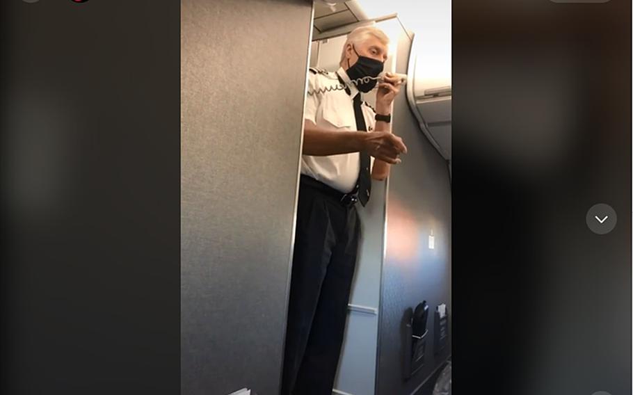 A screenshot from a TikTok video shows an American Airlines crew member paying tribute to Lt. Cmdr. Daniel Nin, whose remains were being transported on the flight.