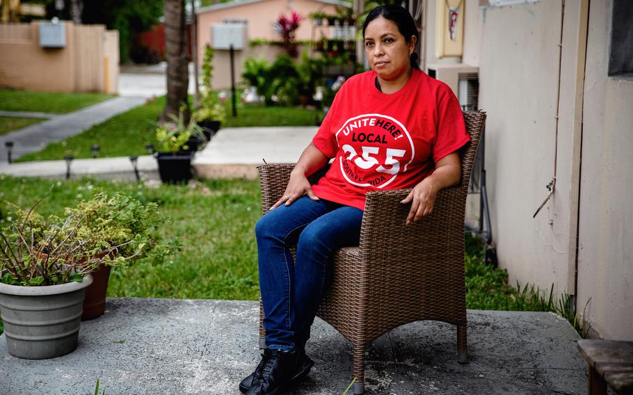 Jacqueline Rodriguez stands for a portrait outside of her home in Miami, FL on Thursday, Jan. 20, 2022. Rodriguez works at a Wendy's location inside the Miami International Airport. Rodriguez has three children and has struggled to keep up with the cost of higher rent, books for her kids' schooling, even paper towels, since her wages have not been raised during the pandemic. She said she is one of three cashiers doing the work of what is normally seven employees, and the airport is busier than ever. 