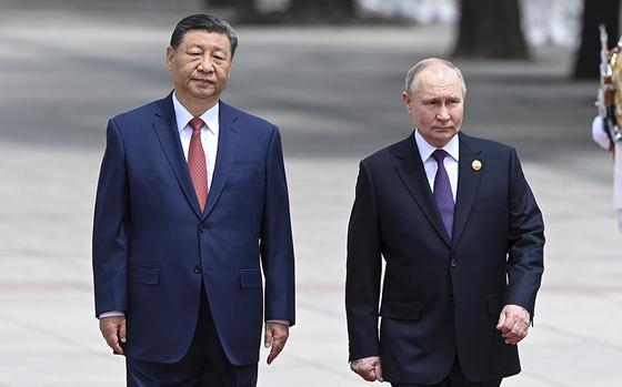 Chinese President Xi Jinping, left, and Russian President Vladimir Putin review the honor guard during an official welcome ceremony in Beijing on May 16, 2024.
