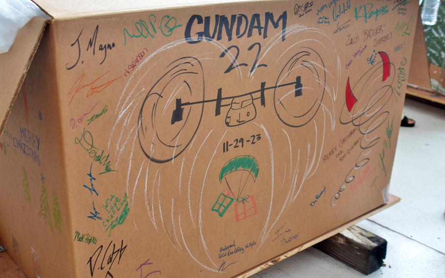 Operation Christmas Drop bundle art drawn at Andersen Air Force Base, Guam, Saturday, Dec. 2, 2023, pays tribute to the crew of a CV-22B Osprey that crashed recently in southwestern Japan.