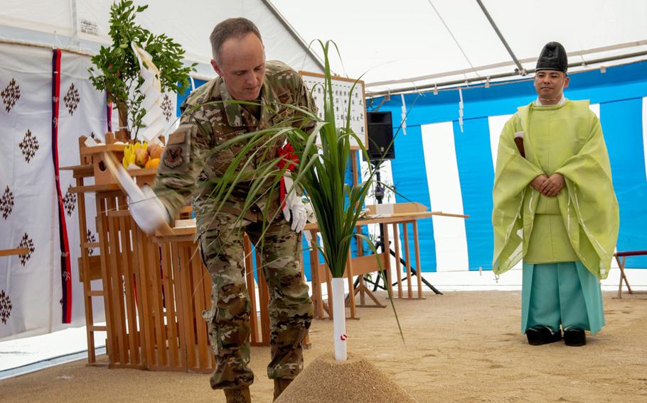The 18th Wing's vice commander, Col. Joshua Lundeby, takes part in a Shinto groundbreaking ritual for the 33rd Rescue Squadron's new hangar at Kadena Air Base, Okinawa, April 17, 2024.